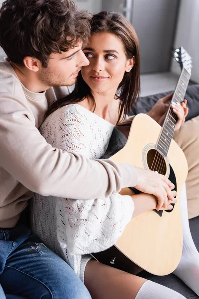 Donna Sorridente Che Suona Chitarra Acustica Guarda Fidanzato Casa — Foto Stock