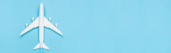 top view of white plane model on blue background, banner