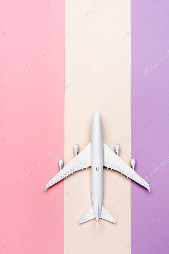 top view of white plane model on colorful background