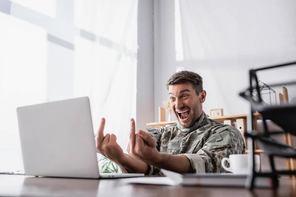 Excited Military Man Showing Middle Fingers Laptop Document Tray Blurred — Stock Photo, Image