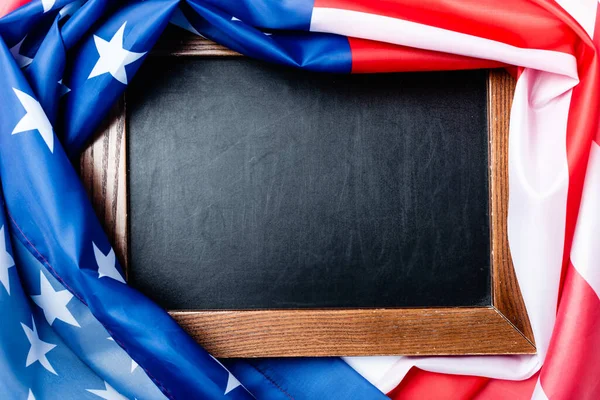 top view of blank chalkboard near flag of american with stars and stipes 