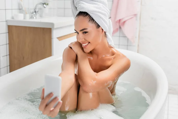 Cheerful Woman Taking Selfie Smartphone Blurred Foreground Bathroom — Stock Photo, Image