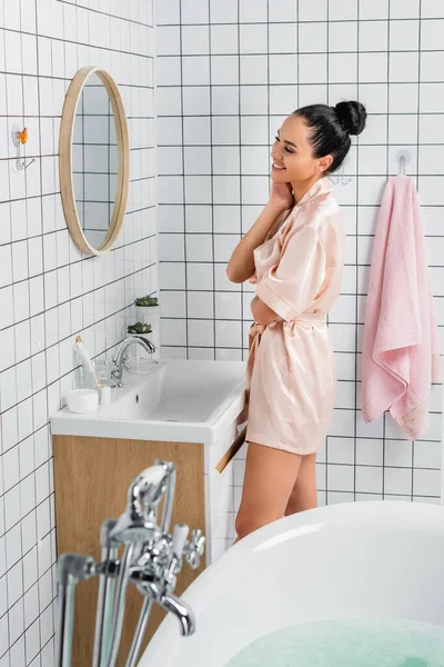 Femme Joyeuse Peignoir Soie Regardant Miroir Près Baignoire Sur Premier — Photo