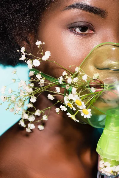 Closeup African American Young Woman Flowers Inhaler Isolated Blue Background — Stock Photo, Image