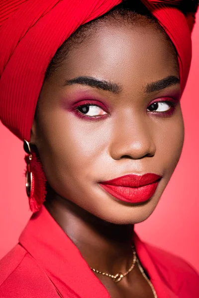 stock image african american young woman in stylish outfit and turban isolated on red