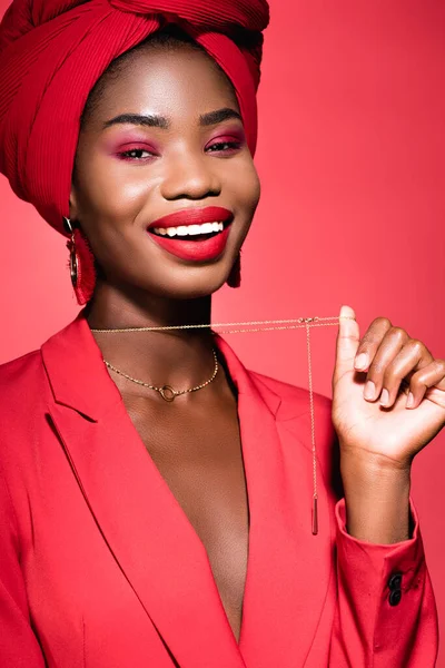 Smiling African American Young Woman Stylish Outfit Turban Holding Necklace — Stock Photo, Image