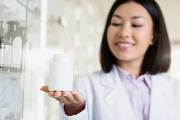 Bottle Medication Hand Cheerful Asian Pharmacist Blurred Background — Stock Photo, Image