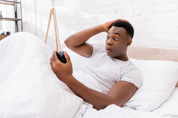 Excited African American Man Looking Clock Bed Morning — Stock Photo, Image