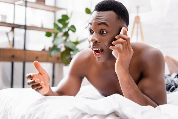 Homem Americano Africano Excitado Falando Smartphone Cama — Fotografia de Stock