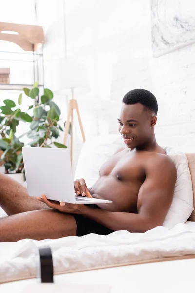 Cheerful African American Man Underpants Using Laptop Bed Blurred Foreground — Stock Photo, Image