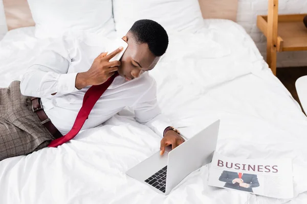 Hombre Negocios Afroamericano Hablando Por Teléfono Inteligente Usando Portátil Cerca — Foto de Stock