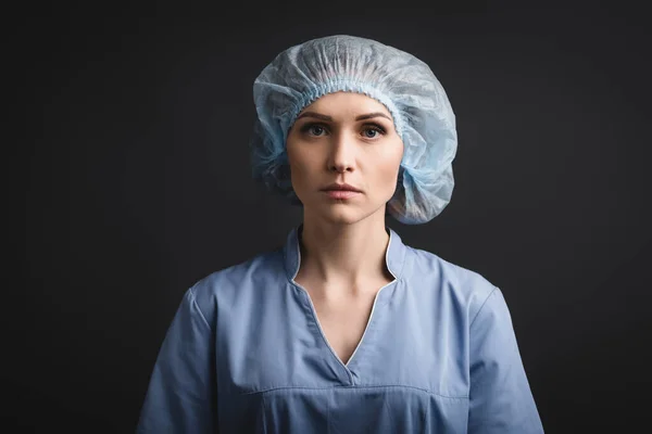 Serious Nurse Blue Medical Cap Looking Camera Isolated Dark Grey — Stock Photo, Image