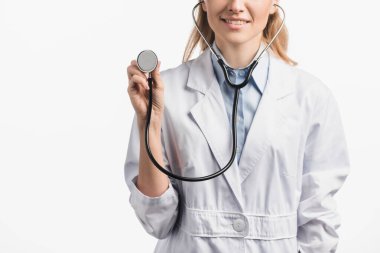 cropped view of happy nurse in white coat holding stethoscope isolated on white clipart