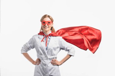 happy nurse in superhero mask and cloak standing with hands on hips isolated on white clipart