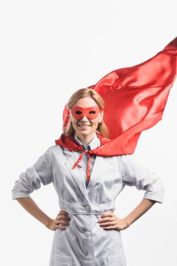cheerful nurse in superhero mask and cloak standing with hands on hips isolated on white clipart