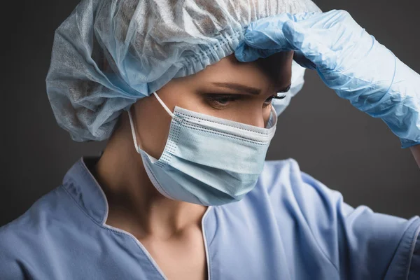 Tired Nurse Medical Cap Mask Having Headache Isolated Dark Grey — Stock Photo, Image