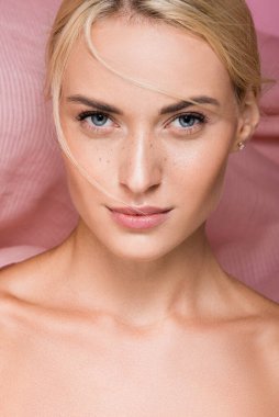 beautiful blonde woman with freckles and bare shoulders near curtain clipart