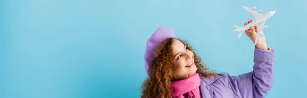 Positive Woman Beret Scarf Coat Holding Toy Plane Blue Banner — Stock Photo, Image