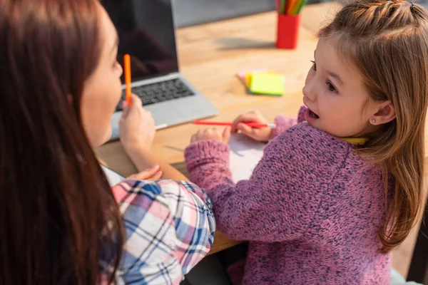 Excited Daughter Open Mouth Looking Mother Blurred Laptop Foreground — Stock Photo, Image