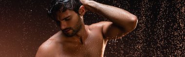 sexy shirtless man posing with closed eyes under rain on dark background, banner clipart