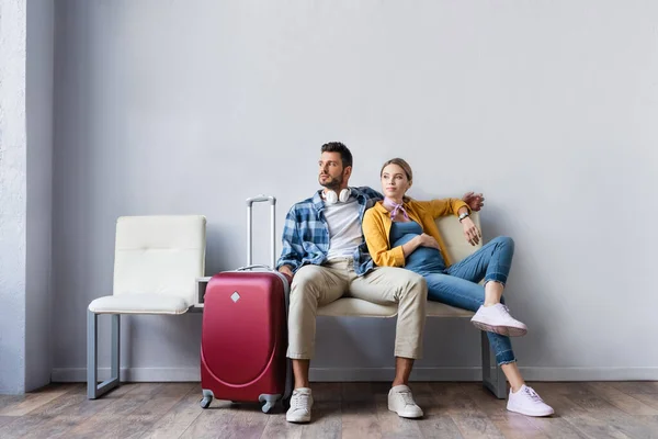 Pregnant Woman Sitting Husband Suitcase Airport — Stock Photo, Image
