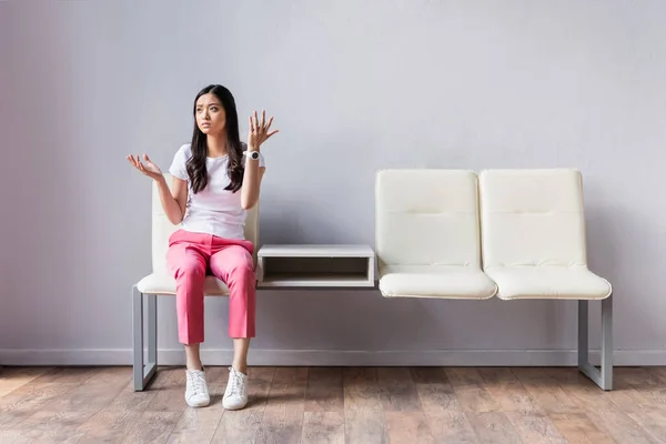 Dissatisfied Asian Woman Looking Away While Waiting Hall — Stock Photo, Image