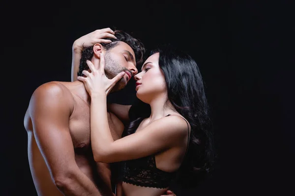 Seductive Brunette Woman Embracing Head Young Shirtless Man Isolated Black — Stock Photo, Image