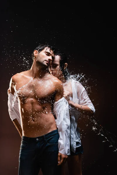 Mujer Joven Desnudándose Sexy Hombre Musculoso Cerca Salpicaduras Agua Sobre — Foto de Stock