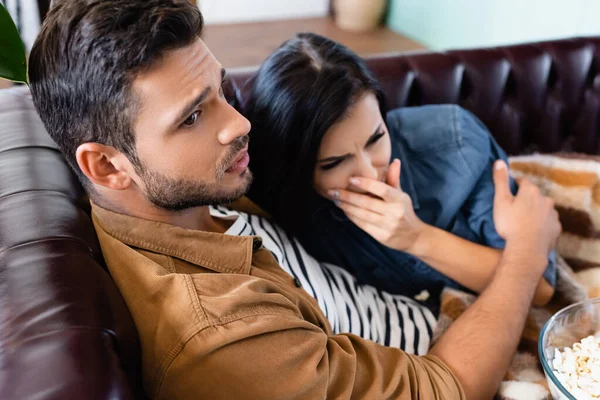 Tense Man Hugging Worried Woman Covering Mouth Hand While Watching — Stock Photo, Image