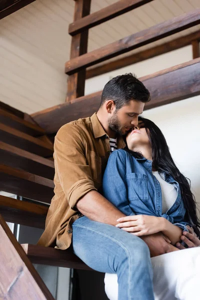 Young Lovers Casual Clothes Kissing While Sitting Wooden Stairs Home — Stock Photo, Image