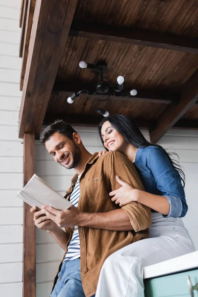 Low Angle View Smiling Woman Embracing Arm Boyfriend Reading Book — Stock Photo, Image