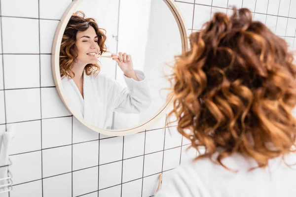 Woman Bathrobe Brushing Teeth Mirror Blurred Foreground — Stock Photo, Image
