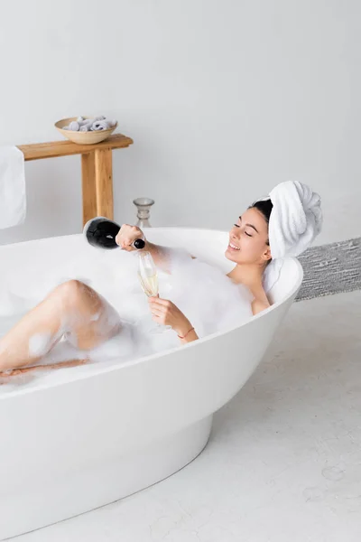 Smiling Woman Pouring Champagne Glass Bathtub — Stock Photo, Image