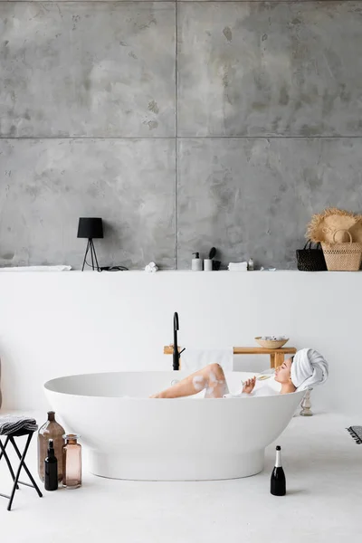 Young Woman Drinking Champagne While Taking Bath Foam — Stock Photo, Image