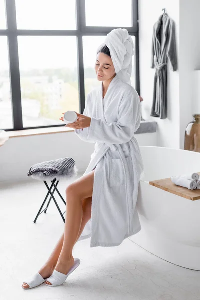 Woman White Bathrobe Holding Jar Cosmetic Cream Bathroom — Stock Photo, Image