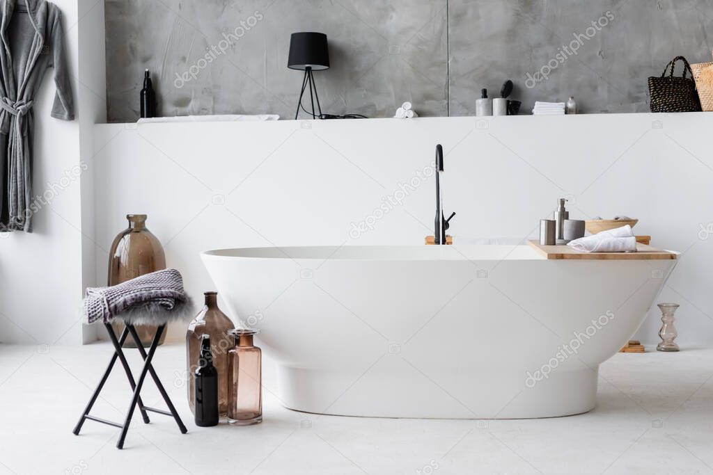 Interior of modern bathroom with decorative bottles 