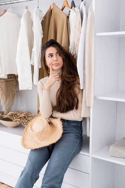 Pensive Woman Sun Hat Sitting Shelf Wardrobe — Stock Photo, Image