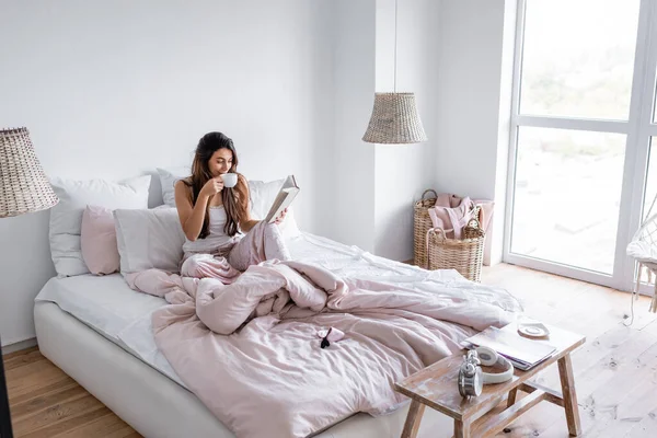 Frau Trinkt Kaffee Und Liest Buch Modernen Schlafzimmer — Stockfoto