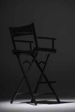 black director chair on dark grey background, cinema concept clipart