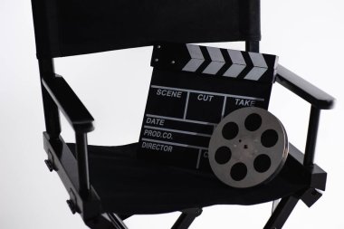 filmmaker chair, clapperboard and film bobbin on white, cinema concept clipart