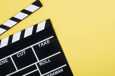 top view of clapperboard on yellow background with copy space, cinema concept clipart