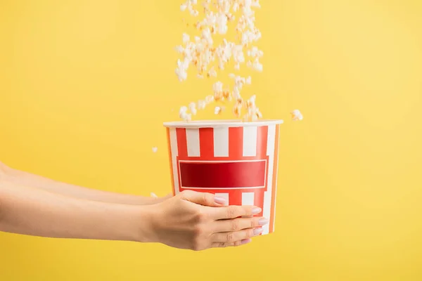 Tasty Popcorn Falling Striped Bucket Female Hands Isolated Yellow Cinema — Stock Photo, Image