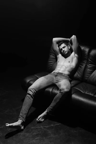 Monochrome Shot Sexy Man Looking Camera Couch Isolated Black — Stock Photo, Image