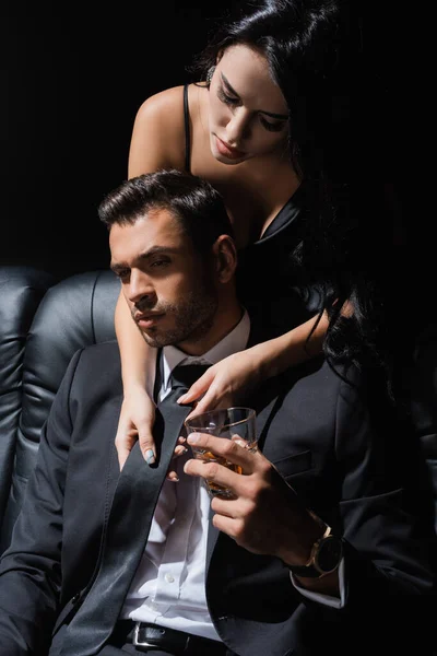 Passionate Woman Holding Tie Man Whiskey Couch Isolated Black — Stock Photo, Image