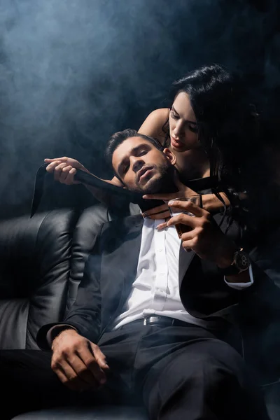 Man Suit Holding Whiskey Sexy Woman Couch Black Background Smoke — Stock Photo, Image