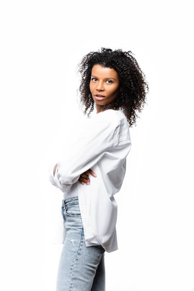 African american woman with crossed arms looking at camera isolated on white 