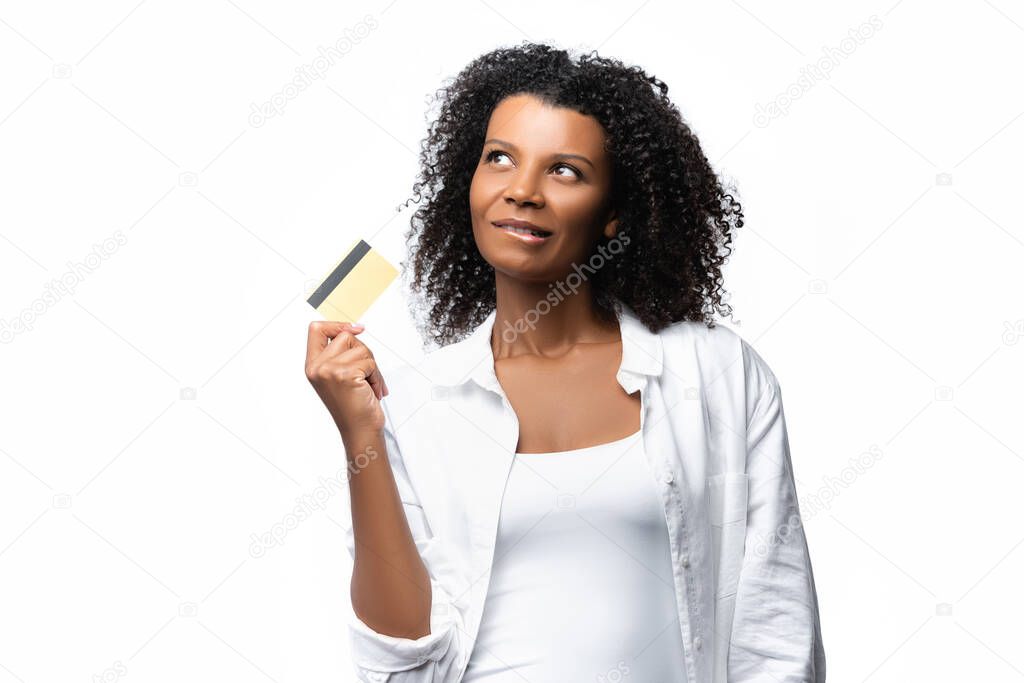 Pensive african american woman holding credit card isolated on white 