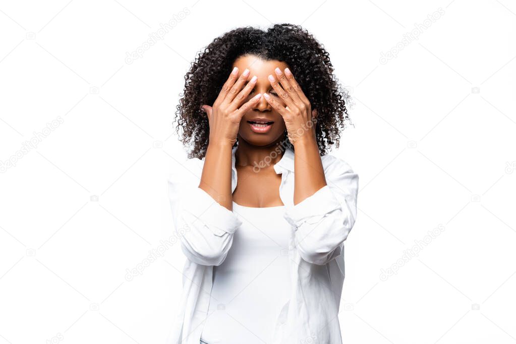 African american woman covering face with hands isolated on white