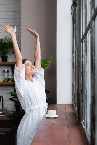 Happy Young Adult Woman Bathrobe Standing Window Hands Air Modern — Stock Photo, Image