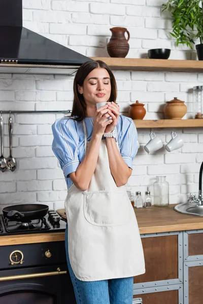 Tersenyum Muda Wanita Dewasa Mencium Aroma Kopi Cangkir Putih Dapur — Stok Foto